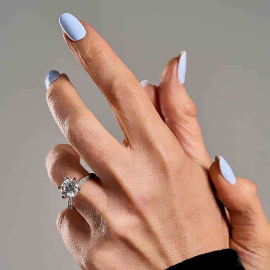 Solitaire ring with 3 ct brilliant cut moissanite worn on hand in 925 sterling silver
