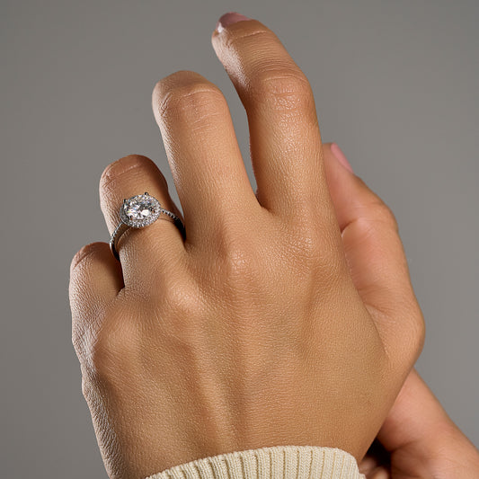 Woman wearing round halo moissanite ring with 2 ct brilliant cut center stone