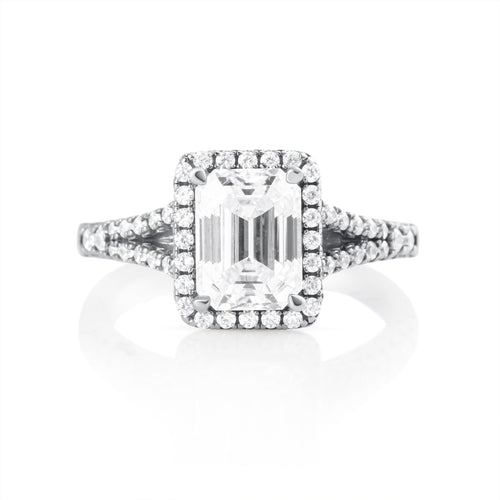 Front view of emerald cut moissanite ring with 2 ct center stone and halo setting in 925 sterling silver