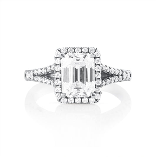 Front view of emerald cut moissanite ring with 2 ct center stone and halo setting in 925 sterling silver