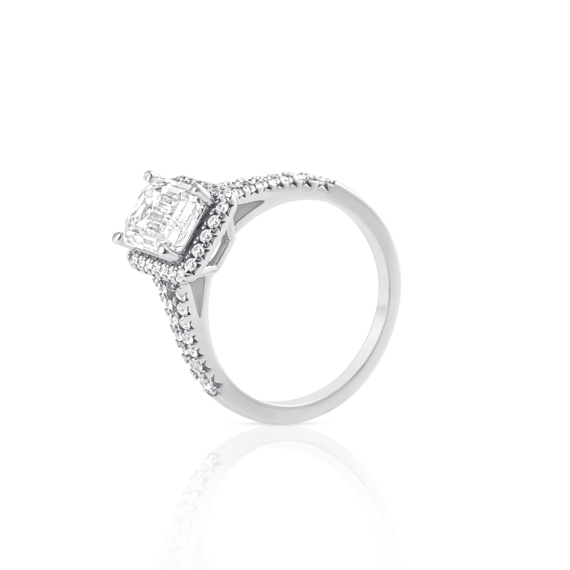 Side view of emerald cut moissanite ring with halo setting in platinum plated sterling silver