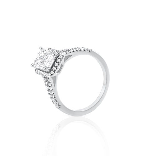 Side view of emerald cut moissanite ring with halo setting in platinum plated sterling silver