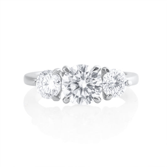 Trilogy ring with 2.2 ct brilliant cut moissanite in platinum plated 925 sterling silver front view