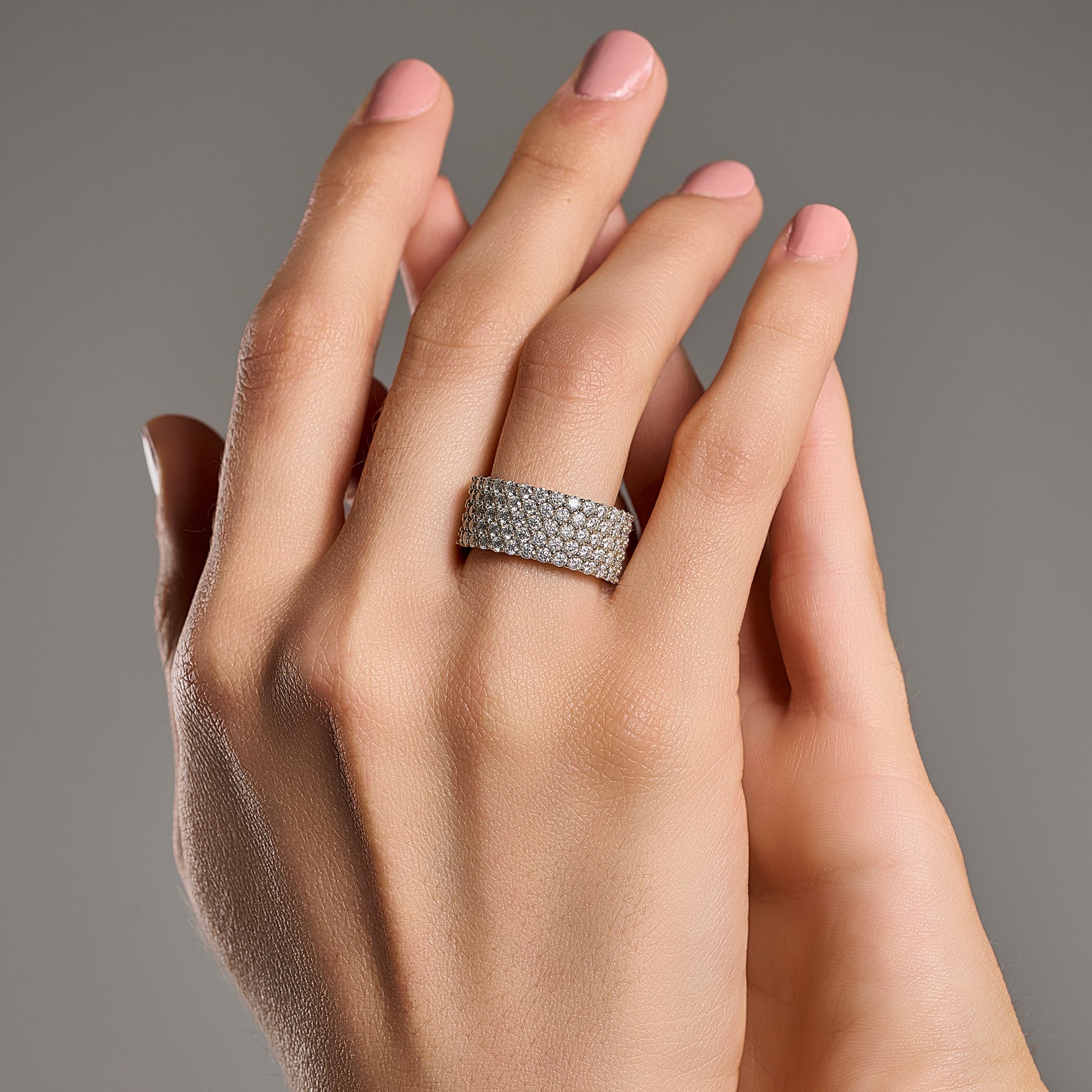 Grand eternity moissanite ring worn on hand in 925 sterling silver