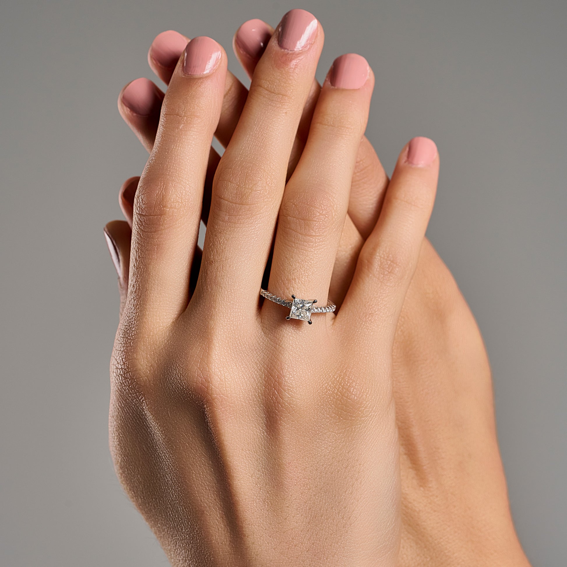 Princess cut 2 ct moissanite ring worn on hand in 925 sterling silver