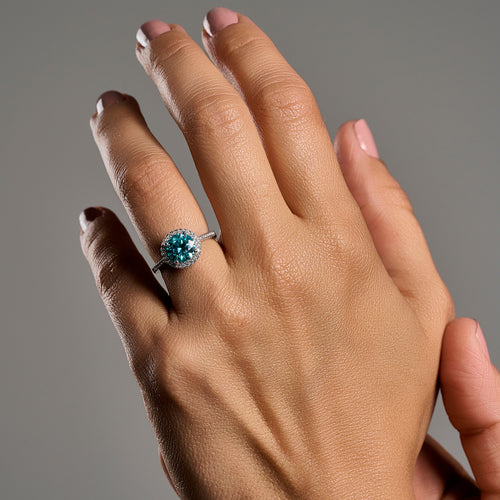 Woman wearing Summer Edition round aquamarine 2ct moissanite ring in 925 sterling silver