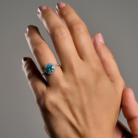 Woman wearing Summer Edition round aquamarine 2ct moissanite ring in 925 sterling silver