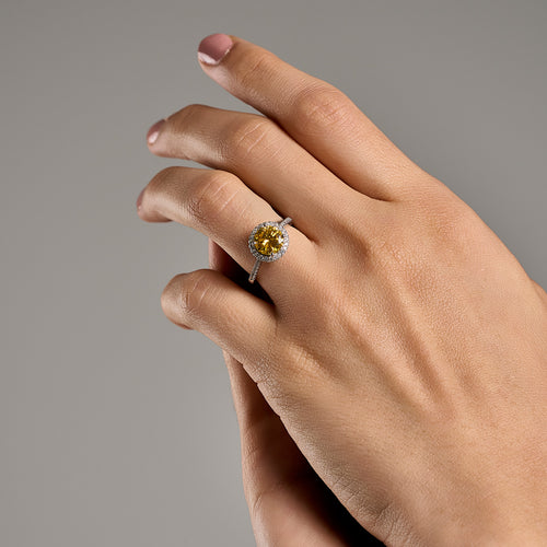 Woman wearing Summer Edition round yellow 2ct moissanite ring in 925 sterling silver