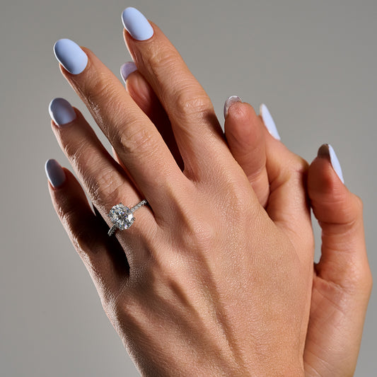 Woman wearing oval cut 3ct moissanite ring in 925 sterling silver