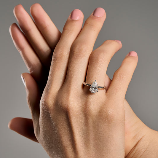 Woman wearing a limited edition pear cut moissanite ring with 3 ct stone