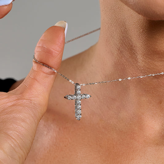 Close-up of a model wearing a 3mm cross necklace with brilliant cut moissanite in 925 sterling silver.