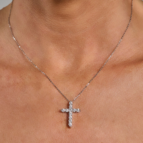 Model wearing a 3mm cross necklace with brilliant cut moissanite in 925 sterling silver.