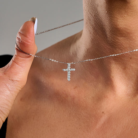 Close-up of a model wearing a 2mm cross necklace with brilliant cut gemstones in 925 sterling silver.