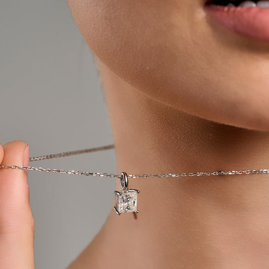 Model wearing a 925 sterling silver necklace with a 2 ct princess cut moissanite pendant in a close-up styling shot.