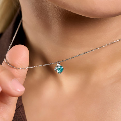 Summer Edition aquamarine light point necklace in 925 sterling silver with 1 ct moissanite held near the neck