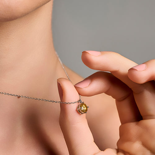 Summer Edition yellow light point necklace in 925 sterling silver with 1 ct moissanite held near the neck