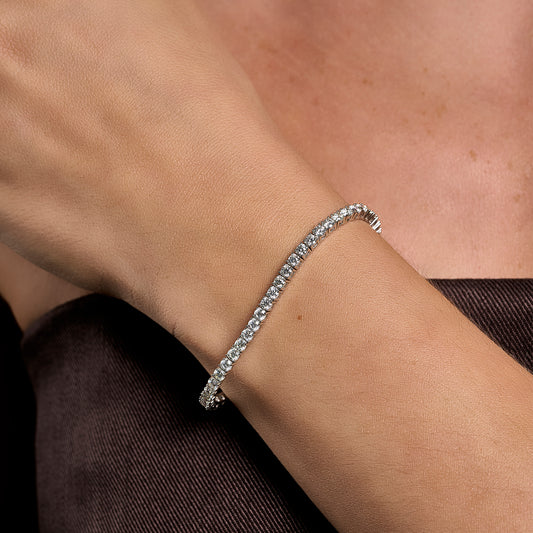 925 sterling silver tennis bracelet with 3 mm brilliant cut moissanite stones worn on wrist
