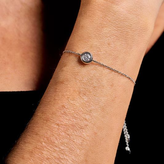 Adjustable fine bracelet in 925 sterling silver with 0.5 ct brilliant cut moissanite worn on wrist