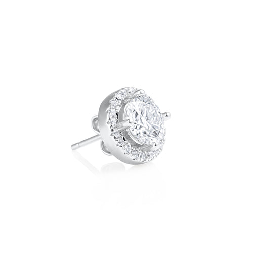 Angled side view of a Round Contorno earring featuring a 1 ct brilliant cut moissanite center stone with a pavé halo setting in 925 sterling silver.