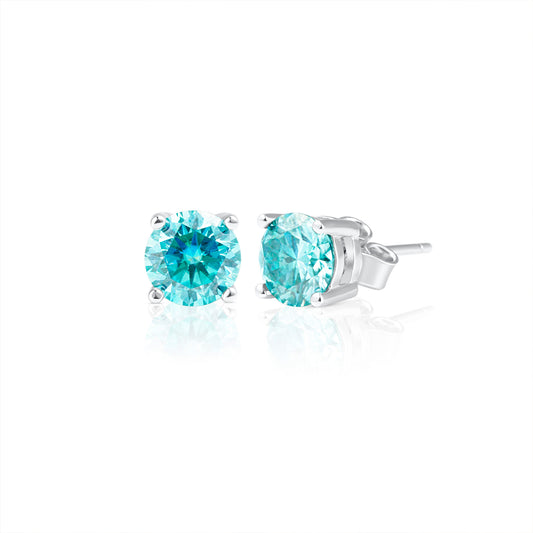 Pair of Summer Edition round aquamarine moissanite stud earrings featuring 1 ct brilliant cut stones set in 925 sterling silver, displayed on a white background.